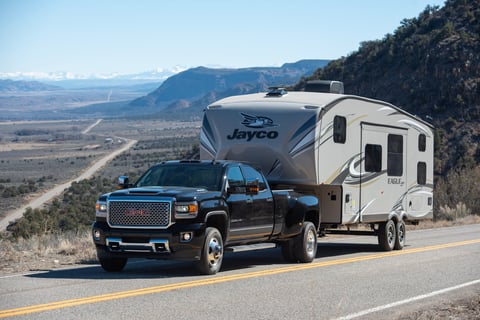 Fifth wheel RV being towed through Arizona mountains