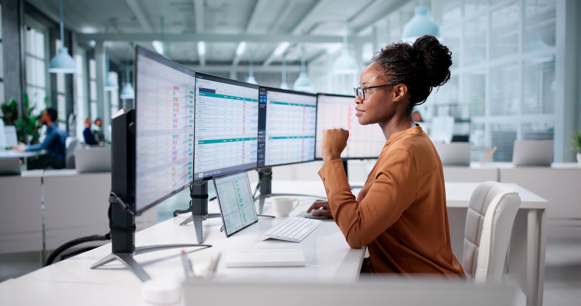 Woman using spreadsheet on computer in modern office