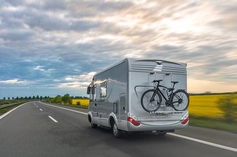 Modern gray motorhome driving on a highway
